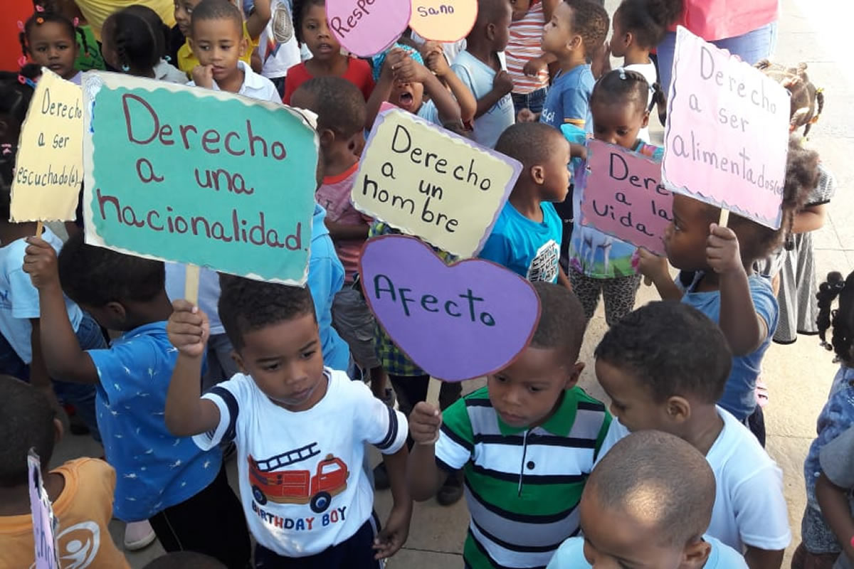 Niños con pancarta Derechos de la Niñez