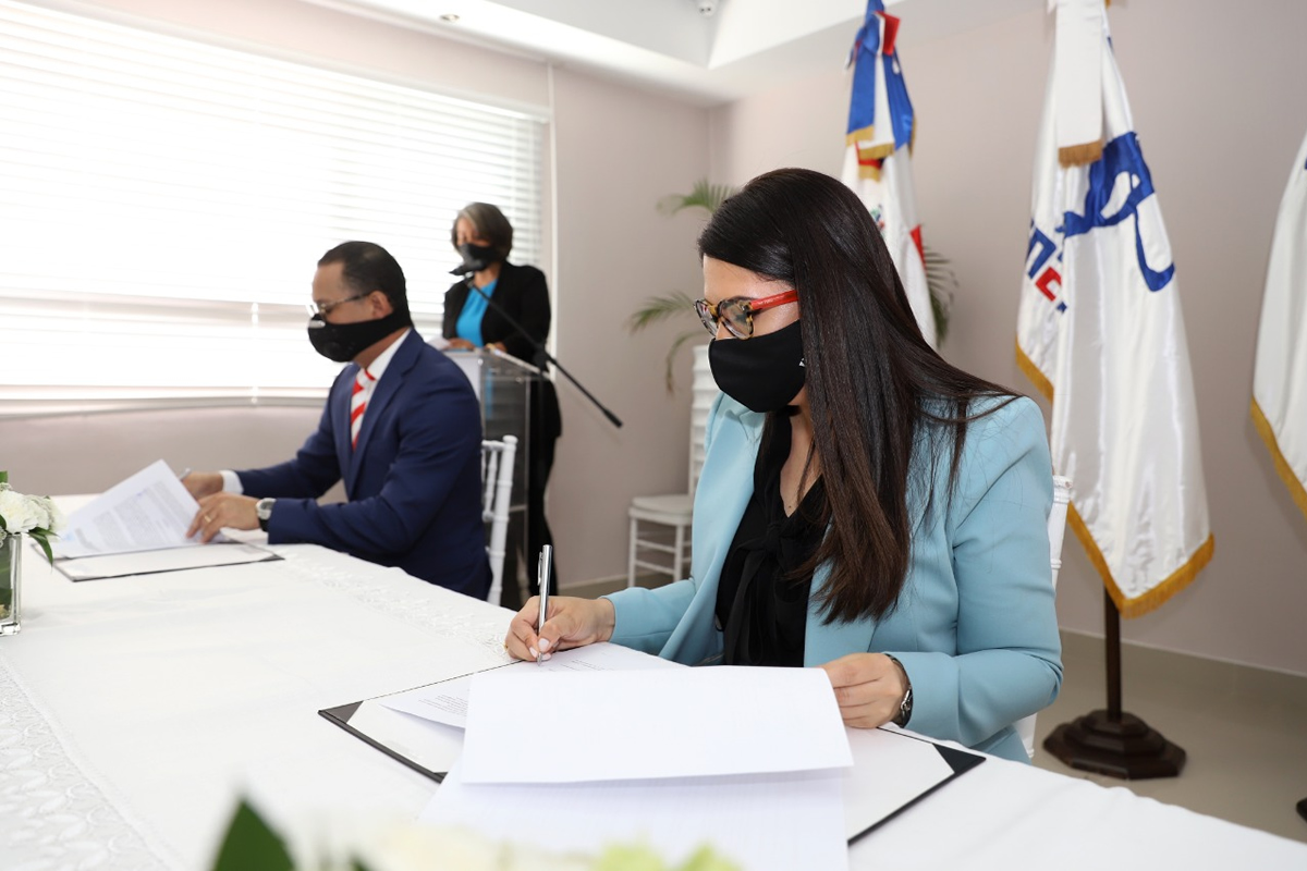El ingeniero Jorge Minaya (por el INEFI) y Kenia Lora  (por el INAIPI) en la firma del convenio
