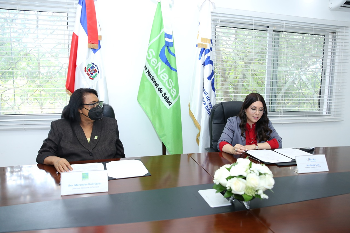 Mercedes Rodríguez Silver, directora ejecutiva de SeNaSa, y Kenia Lora, directora del INAIPI, durante la firma del acuerdo
