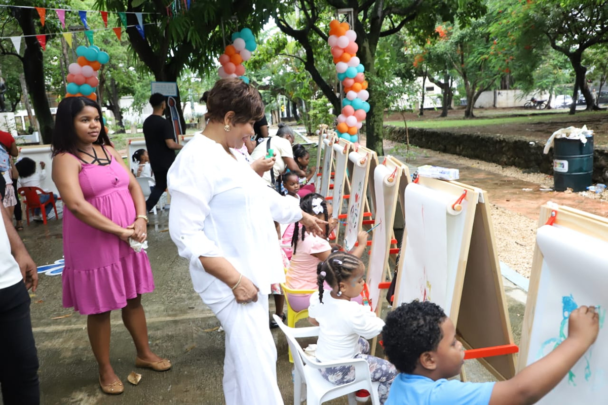Josefa Castillo Rodríguez, directora ejecutiva del INAIPI, observa mientras los niños pintan durante la actividad